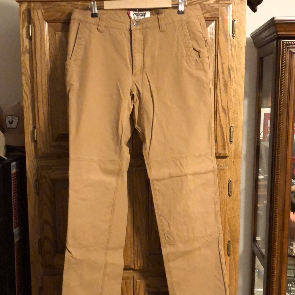 Mountain khaki brown pants, worn twice. One 2” hole on pocket. No flaws/stains.